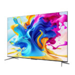 Flat-screen television on a two-legged stand displaying a bright, abstract color splash wallpaper.